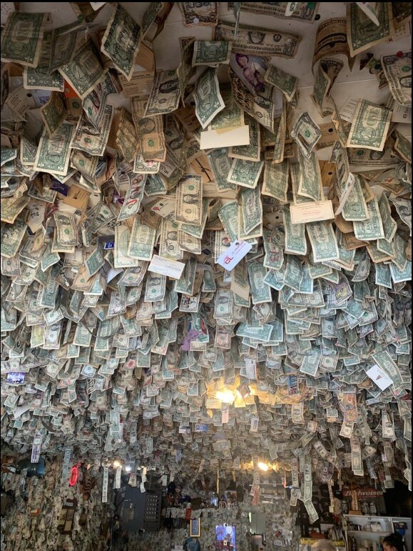 Dollar bills hang on the walls and ceiling of Fat Smitty’s.